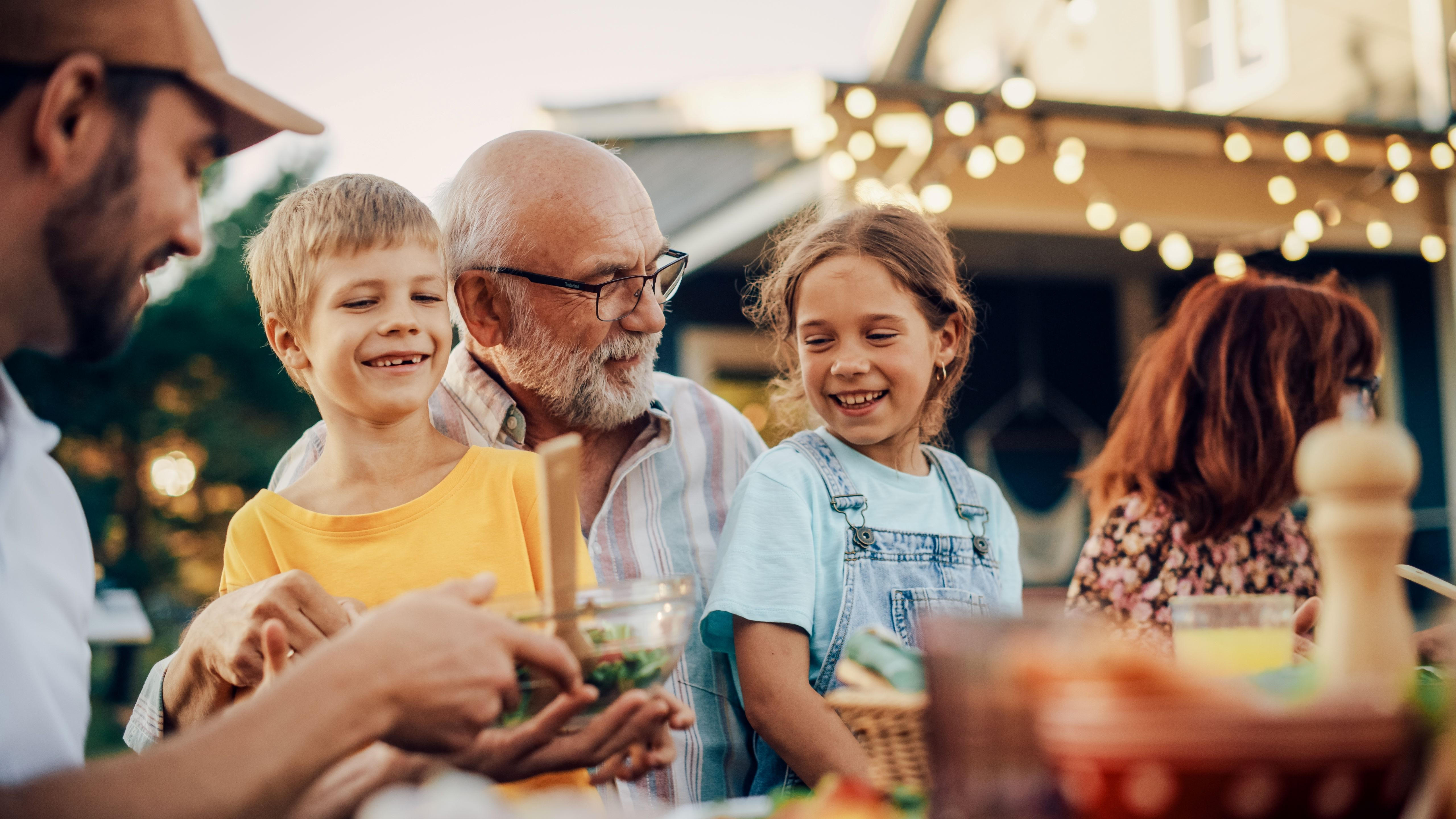Familie eten in de tuin aan een tafel